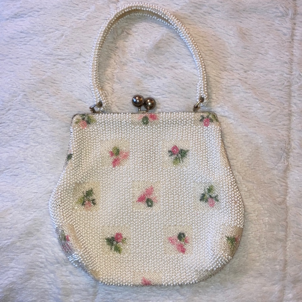 Vintage beaded small purse with handle and flower motifs.